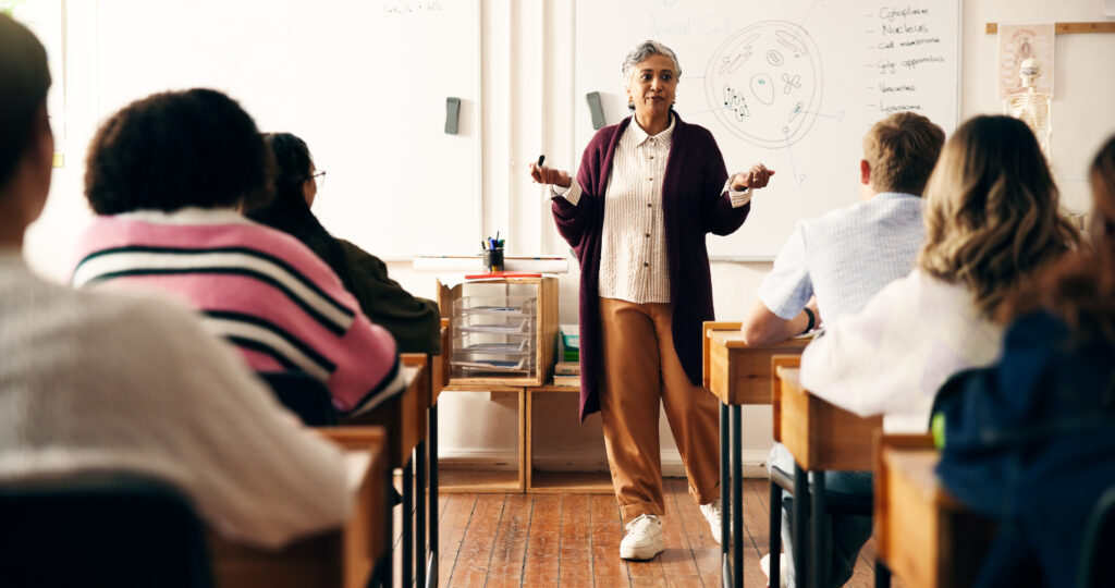 2P Blog 2 educator-students-woman-classroom-with-whiteboard-speaking-listen-biology-lesson-knowledge-nature-science-mature-high-school-teacher-academy-with-teens-learning-future-exam
